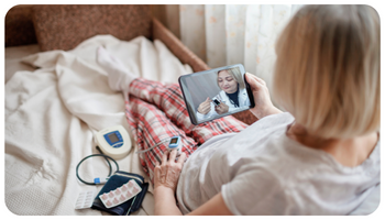 Image of a woman using a telehealth device